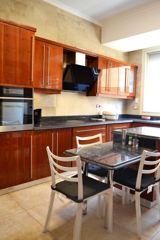 brown modern kitchen cabinets with cherry veneers and a dining area مطبخ مودرن