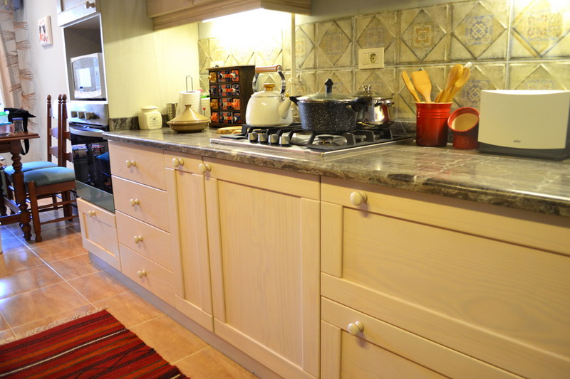 beige pitch pine kitchen cabinets with built-in appliances