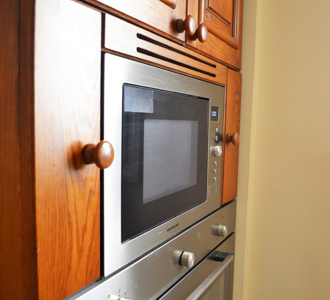 Oak classic brown kitchen with built-in microwave