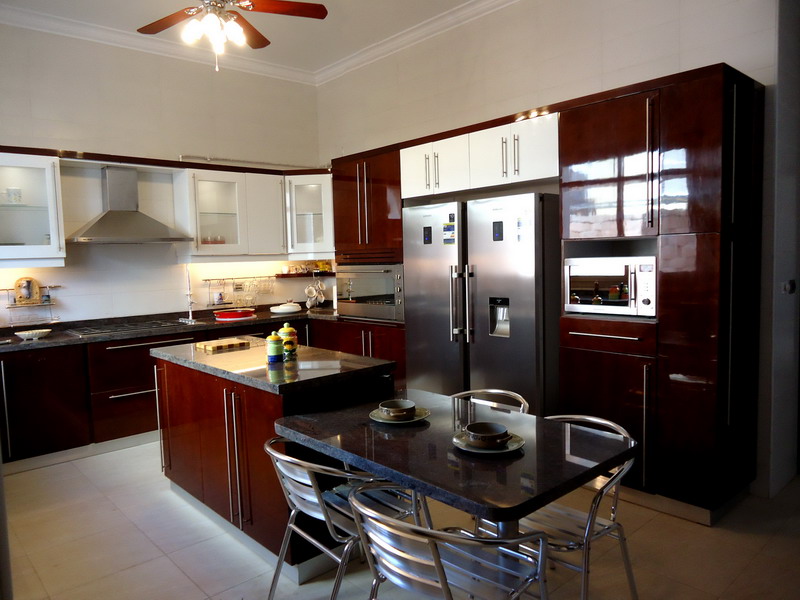 modern white and brown kitchen with dining area and kitchen island