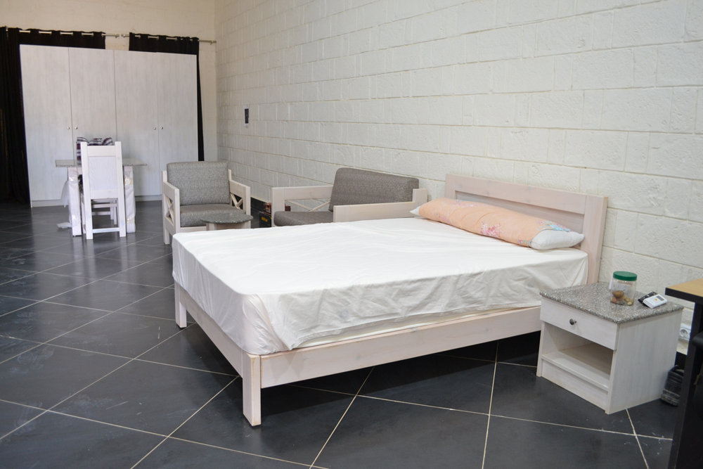 dorm room furniture bed, side table, and chairs